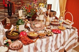 Romanian language traditional food presented through different types of sausage at traditional wedding reception table.