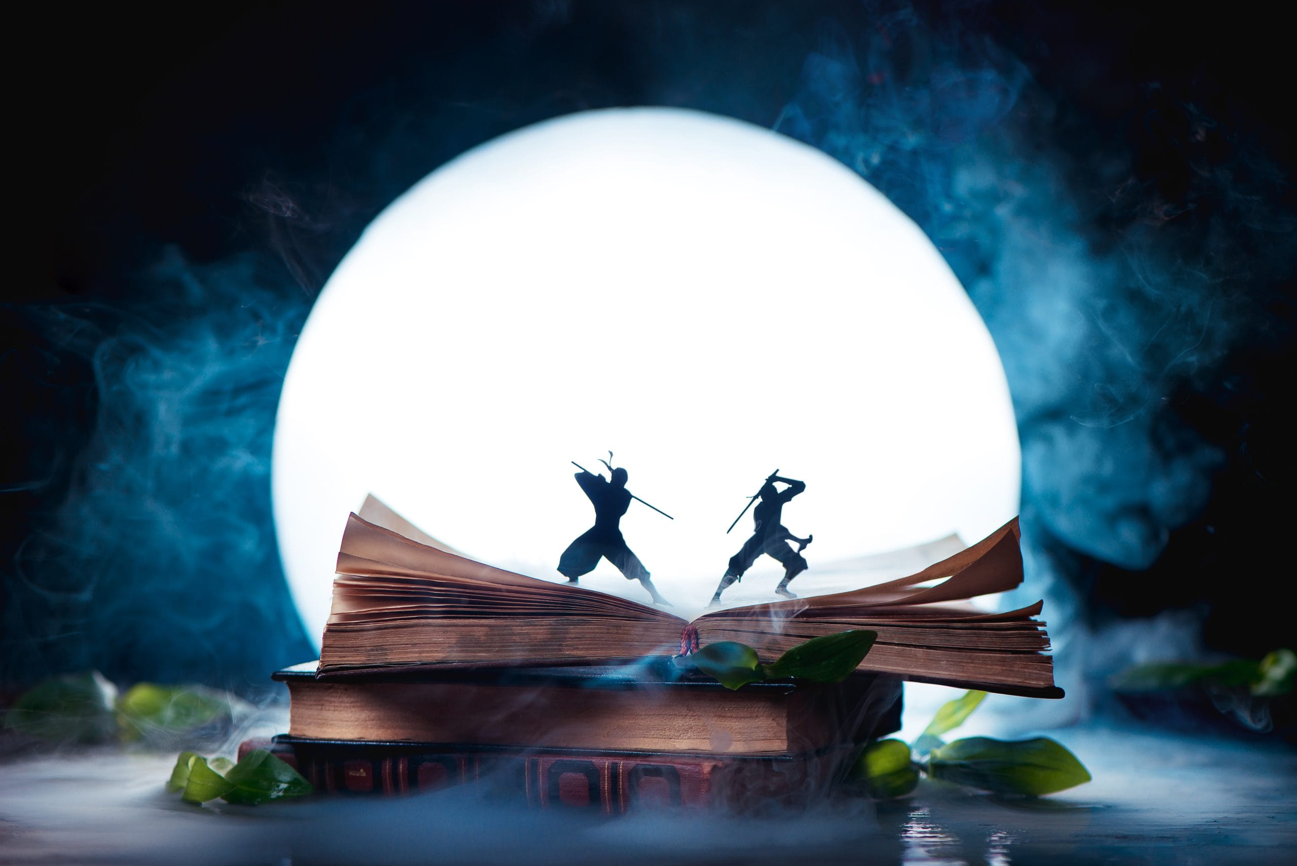 Sports in Romanian presented in an open book about with two ninja warrior silhouettes fighting in full Moon. Reader imagination and writing inspiration concept with copy space
