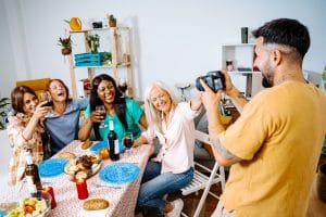 Group of Friends Enjoying a Festive Home Gathering with Wine and Food, showing how to be happy in Romanian .