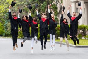 Romanian feelings vocabulary presented by a group of happy students celebrating graduation from university, jumping up