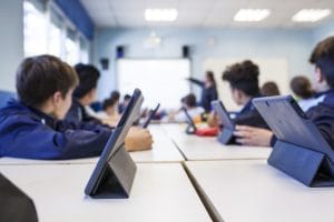 People study in class with their tablet learning Romanian classroom vocabulary
