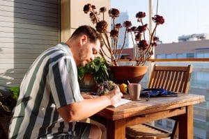 Romanian verbs A2 learned by a man who is taking notes while about sitting at table