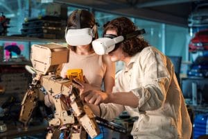 Romanian lessons A2 future tense learned by a young man and a woman in VR glasses doing experiments in robotics in a laboratory