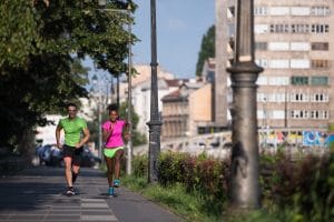 After having Romanian lessons A2 sports, this young smiling multiethnic couple are doing jogging in the city